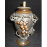 A Japanese bronze vase of baluster form with textured finish applied moulded decoration of grapes