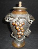 A Japanese bronze vase of baluster form with textured finish applied moulded decoration of grapes