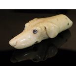 A 19th Century carved bone dog's head whistle with glass eyes, 4.