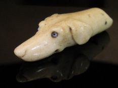 A 19th Century carved bone dog's head whistle with glass eyes, 4.