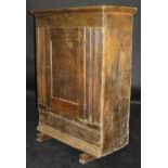 A 17th Century Dutch oak cabinet of plain form with single panelled door enclosing shelves with