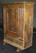 A 17th Century Dutch oak cabinet of plain form with single panelled door enclosing shelves with