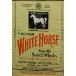 A framed and glazed "White Horse Fine Old Scotch Whisky" Irish linen panel with printed decoration,
