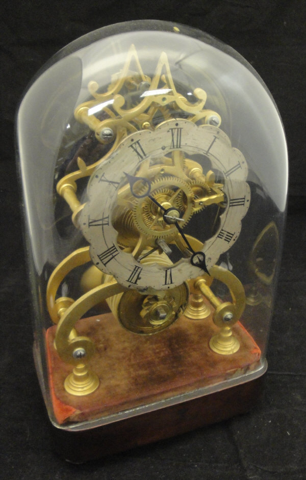 A 19th Century brass skeleton clock with single fusée movement and shaped circular silvered chapter