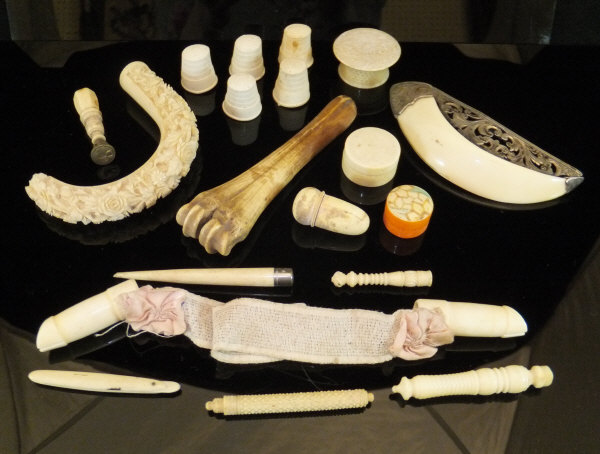 A collection of various carved ivory and bone items to include apple corer, counters, thimbles,