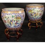 A pair of 20th Century Chinese porcelain polychrome decorated fish bowls decorated with panels of