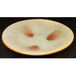 A Chinese crackle ware celadon glazed and sang de boeuf flash decorated shallow bowl in the Sung