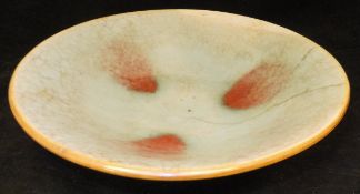 A Chinese crackle ware celadon glazed and sang de boeuf flash decorated shallow bowl in the Sung