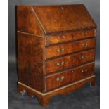 An 18th Century burr brown oak bureau,