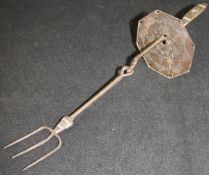 A charcoal iron toasting fork with shield, designed by Ernest Gimson, made by Alfred Bucknell,