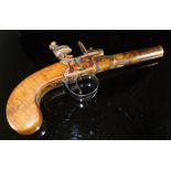 An 18th Century pistol with circular barrel with simply engraved frieze with pinched end,