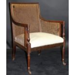 A 19th Century mahogany framed bergère library chair with caned back and arms and upholstered seat,