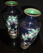 A pair of Japanese Meiji Period black ground elongated urn shaped vases decorated with birds