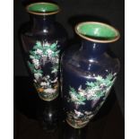 A pair of Japanese Meiji Period black ground elongated urn shaped vases decorated with birds