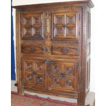 A 17th Century carved oak cupboard with two panelled cupboard doors above two diamond carved