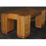 A 1920's French Art Deco walnut veneered partner's desk by Dominique of Paris,