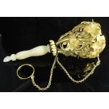 A 19th Century Continental gilt metal posy holder of entwined ivy design with turned mother of