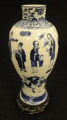 A Chinese blue and white baluster shaped vase decorated with various figures and Swastika emblems