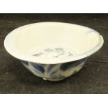 A Ming Dynasty Chinese blue and white bowl with flared rim on a circular foot with all over foliate