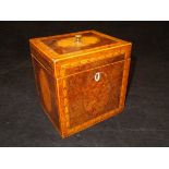A George III burr walnut marquetry and parquetry inlaid tea caddy of rectangular form,