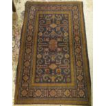 A Caucasian rug, the central panel set with stylised animal motifs on a blue ground,