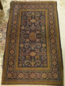 A Caucasian rug, the central panel set with stylised animal motifs on a blue ground,