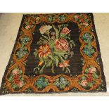 A Caucasian Kelim rug, the central panel set with floral spray design on a black ground,