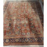 A Ziegler carpet, the central panel set with all over floral decoration on a terracotta ground,