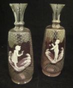 A pair of pale amethyst and white enamel decorated Mary Gregory style vases,