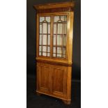 A 19th Century oak corner display cabinet with chamfered pediment above a wide mahogany frieze and
