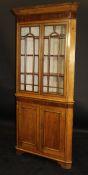 A 19th Century oak corner display cabinet with chamfered pediment above a wide mahogany frieze and