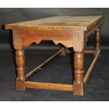 A late 18th / early 19th Century oak refectory dining table with planked top and cleated ends over
