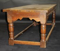 A late 18th / early 19th Century oak refectory dining table with planked top and cleated ends over