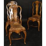 A set of four 18th Century Dutch walnut and marquetry inlaid dining chairs,