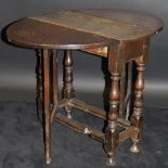 An 18th Century oak oval gate-leg drop-leaf tea table,