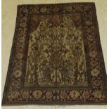 An Ishphan prayer rug, the central panel set with tree and foliate design on a mushroom ground,