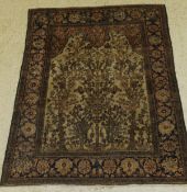 An Ishphan prayer rug, the central panel set with tree and foliate design on a mushroom ground,