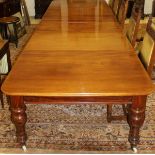 A large early Victorian mahogany extending dining table with four leaves,