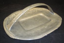 An Archibald Knox for Liberty & Co pewter cake tray of basket form cast with stylised Honesty No