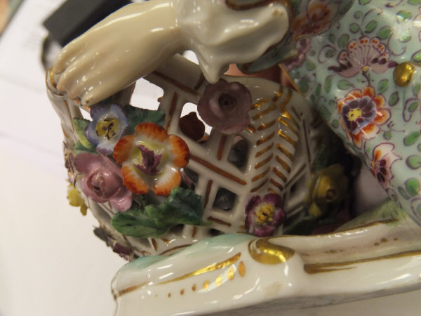 A pair of 19th Century Meissen figures as a recumbent gentleman and lady with baskets of flowers, - Image 12 of 48