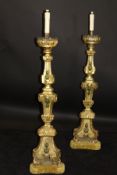A pair of 18th Century Italian giltwood altar candlesticks on a carved moulded architectural column
