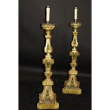 A pair of 18th Century Italian giltwood altar candlesticks on a carved moulded architectural column