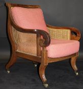 An early 19th Century mahogany framed bérgère armchair with caned seat,