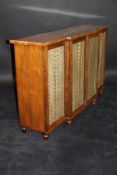 A Regency rosewood breakfront side cabinet with two pairs of brass wirework and silk panelled doors,