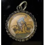 An Essex Crystal compass, the reverse painted with a cyclist in blue and white top,