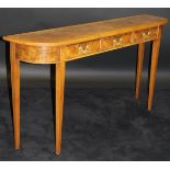 A walnut side table, the figured top feather and cross-banded over three frieze drawers,