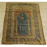 A fine Ushak prayer rug, the central panel set with Mihrab design on a blue ground,