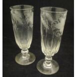 A pair of 19th Century ale glasses, the top half of the bowl decorated with etched barley and vines,