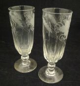 A pair of 19th Century ale glasses, the top half of the bowl decorated with etched barley and vines,