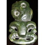 A 19th Century Maori jadite hei tiki of typical form, 8 cm x 4.